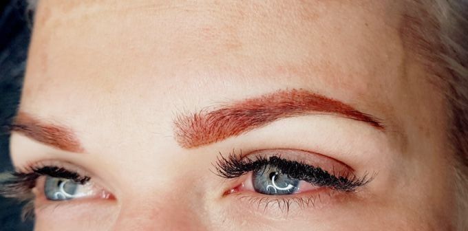 The same eyebrow straight after permanent makeup: a defined, warm auburn brow.