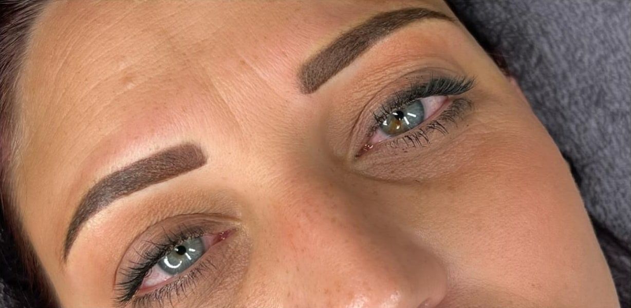 The same client straight after permanent makeup: even, softly powdered brows in cool brown.